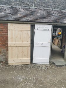 Two wooden doors outside a garage