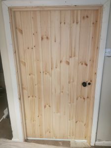 Pine door with black handle