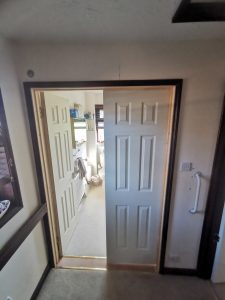 Double wooden doors with one door open