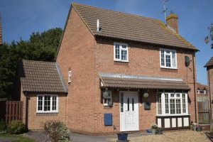 A red brick house with a garage