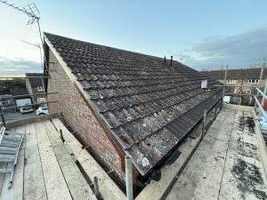 A roof with new slates and scaffolding