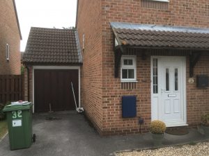 A red brick house with a white door