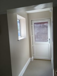 A hallway with a white door