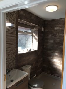 A bathroom with brown tiles
