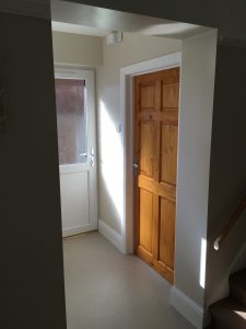 A hallway with a brown door