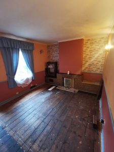 A room with orange walls and blue curtains