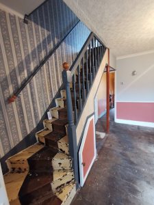 A staircase with blue floral wallpaper