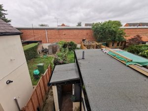 A single storey extension roof overlooking a garden