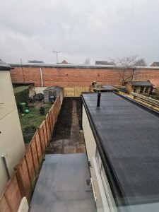 A single storey extension roof overlooking a garden