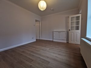 A room with a lampshade and white doors