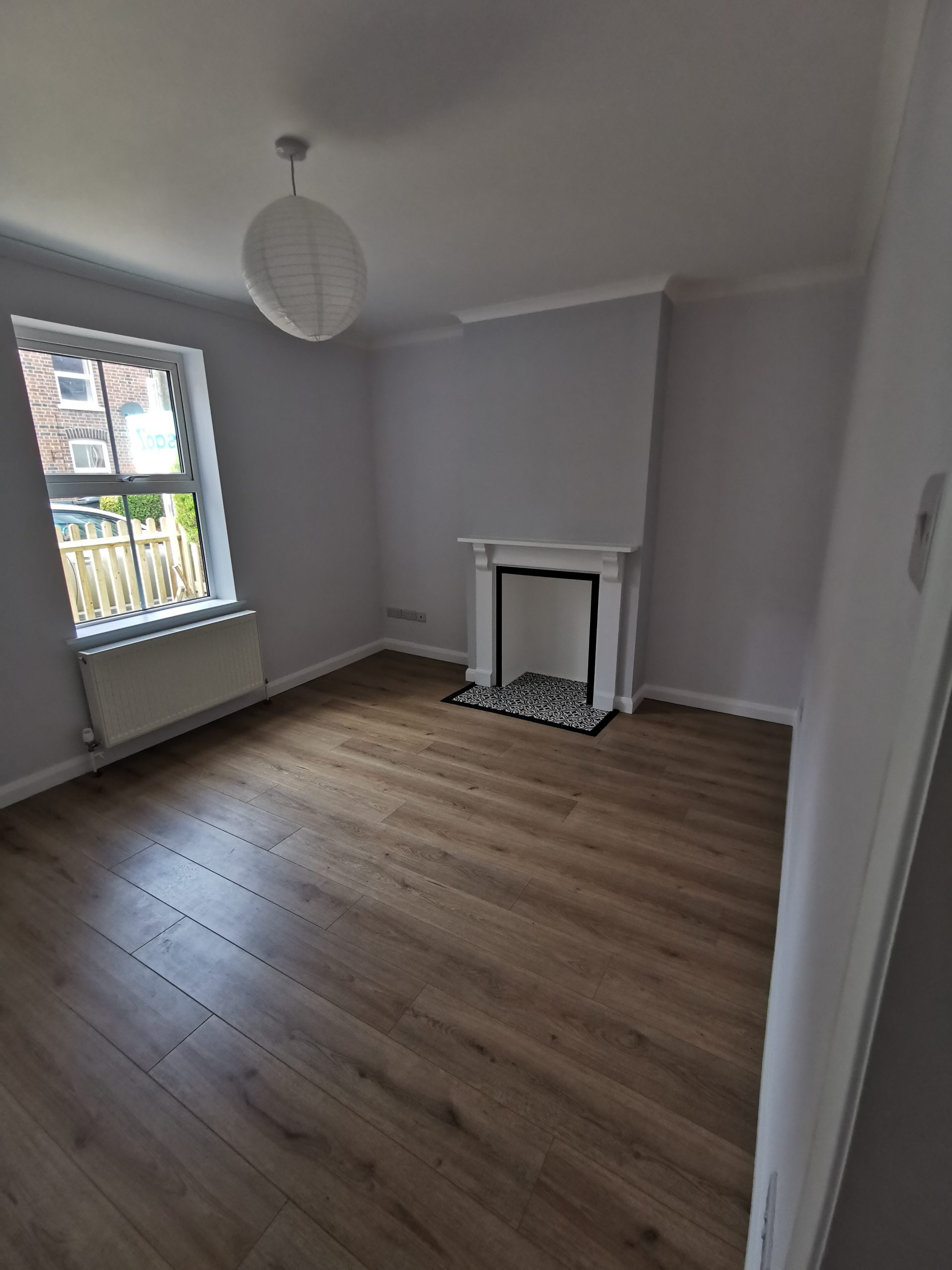 A room with a fireplace and a window