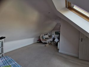 A loft room with a velux window