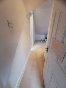 A loft room with a heart poster on the door