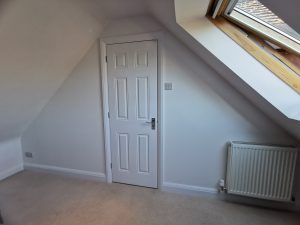 A room with a doorway and a velux window