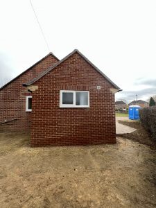 A single storey extension built from red bricks