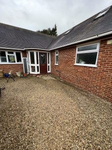 Gravel outside a red brick house