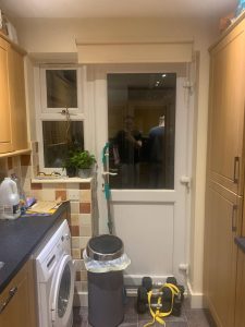 Kitchen with brown cupboards and mixed orange tiles