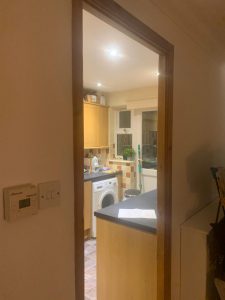 Kitchen with brown cupboards and mixed orange tiles
