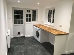 A utility room with wooden worktop