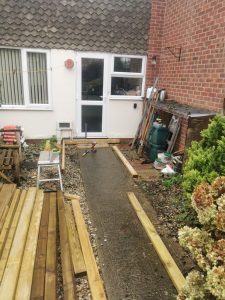 Construction of a wooden ramp leading into a terraced house