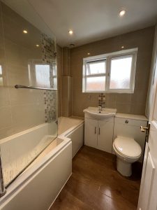 A bathroom with a bath sink and toilet