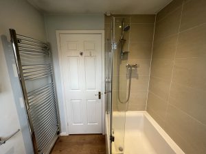 A bathroom with a bath sink and toilet