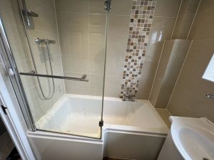 A bathroom with a bath sink and toilet