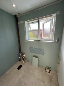 A room with plaster board showing