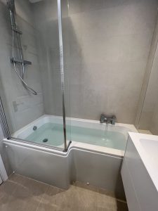 A bathroom with a bath sink and toilet