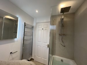 A bathroom with a bath sink and toilet
