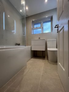 A bathroom with a bath sink and toilet
